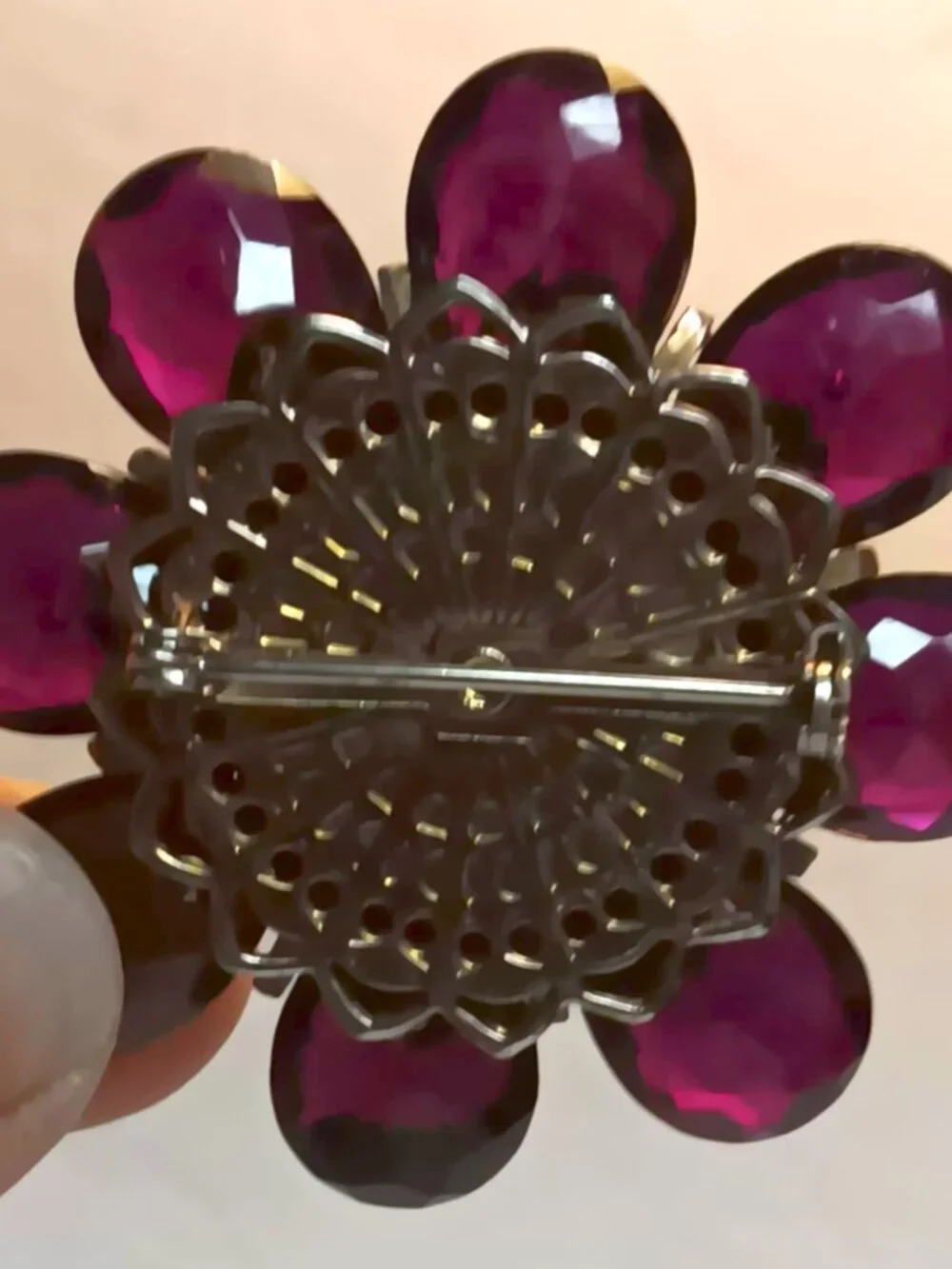 Vintage ruby lucite brooch with aurora borealis central rhinestone.